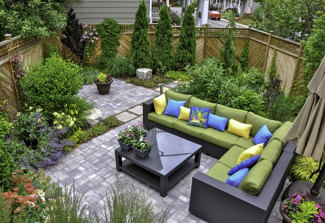 Paved garden patio with outdoor seating and landscaped borders